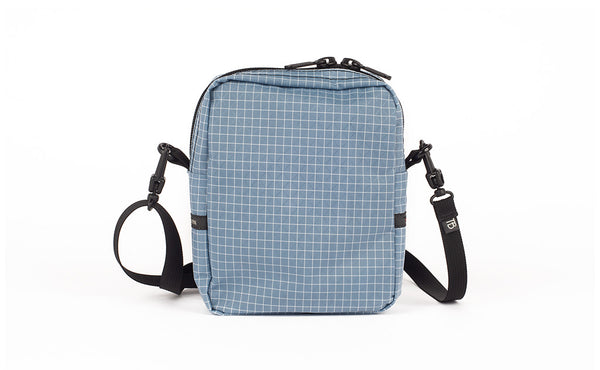 A back view of the Everyday Cubelet in Tidal Halcyon (faded blue with a white grid) showing a completely fabric back.